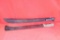 Two machetes. First has large curved 19.0 inch blade. Second has 22.0 inch blade. Neither has a