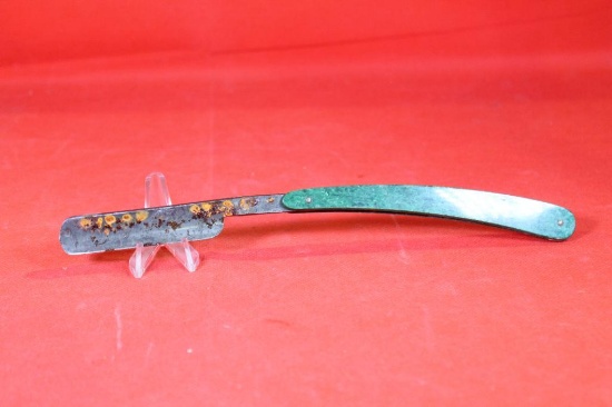 Green plastic handled straight razor. Used, rusty.