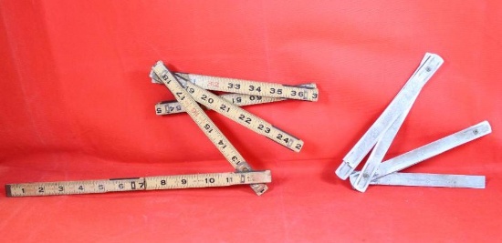 Two Craftsman old style folding rulers, one wood and one metal
