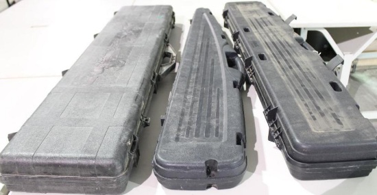 Three hard black plastic rifle cases. Like new.