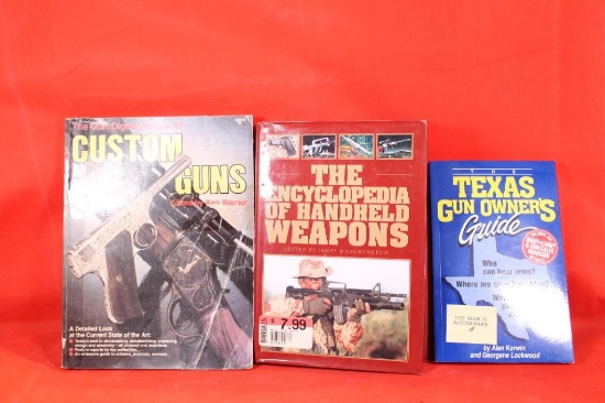 One hardcover book with dust cover, Encyclopedia of Handheld Weapons and two paperbacks. One Texas