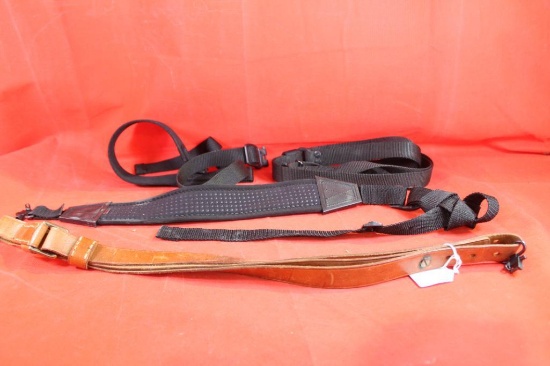 Four rifle slings. Three nylon and one leather.