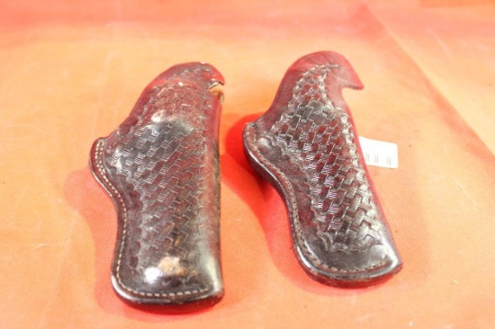 Two black tooled Bianchi leather right handed holsters. Used.