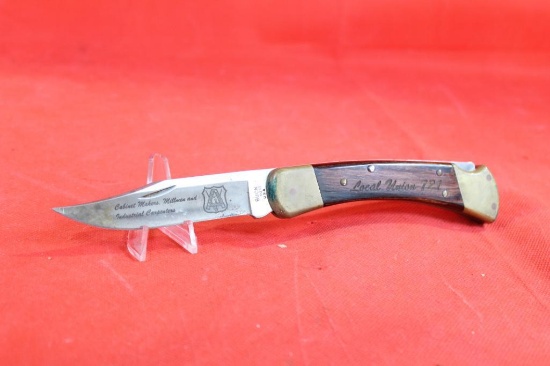 Buck model 110 folding hunter with 3.75 inch blade. Blade is marked "Cabinet Makers, Millmen &
