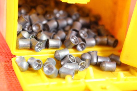 Two Sheridan 5 mm air gun pellets. One full and one partial.
