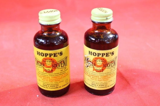 Two bottles of Hoppe's #9 cleaning solution. Both are full.