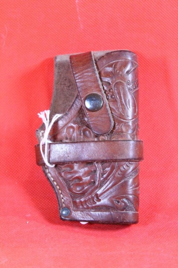 Small tooled brown leather belt holster with trigger loop for snub nose revolver. Used.