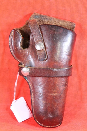 Brown leather right handed single strap belt revolver holster with trigger loop. Used.