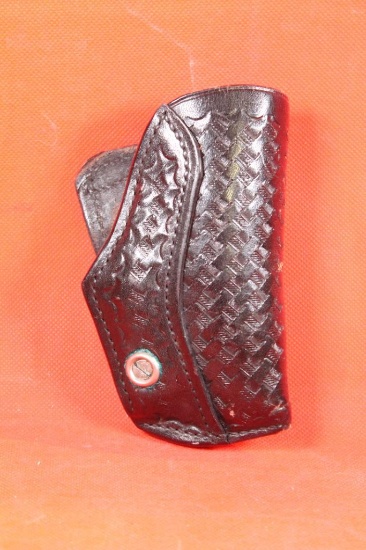 Small tooled black leather right handed quick draw revolver holster. Used.