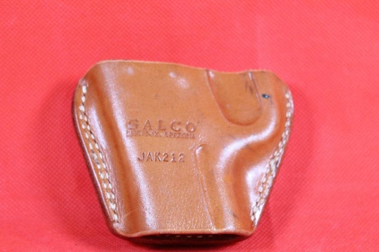 Small Galco brown leather left handed belt holster. Used in good condition.