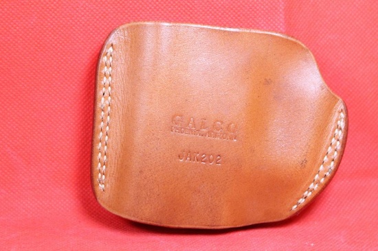 Small Galco brown leather left handed belt holster. Used in good condition.