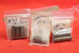 Three small bags with antique brass pistol rounds. One with 2 rounds of 38-44, one with 1 round of
