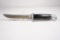 Buck Model 105 single blade hunting knife with 5.0 inch blade. Original sheath. Used in very good