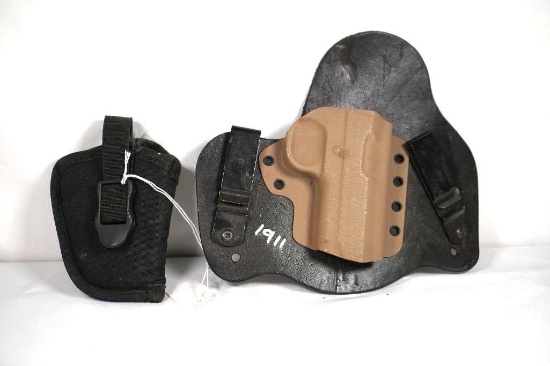 Two holsters one polymer for 1911 and one nylon for small revolver. Used.