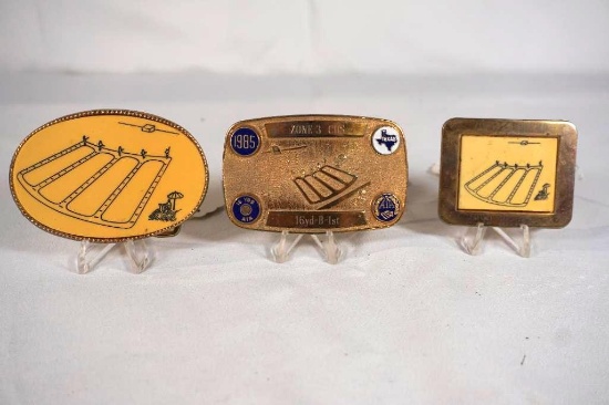 Three brass trap shooting buckles.