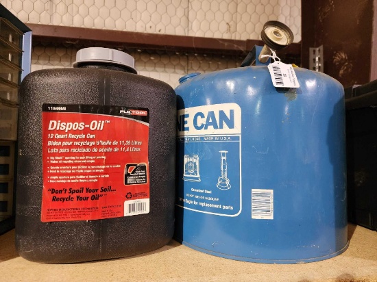 Two fuel containers. One blue metal Kerosene can and, one black plastic for oil disposal.