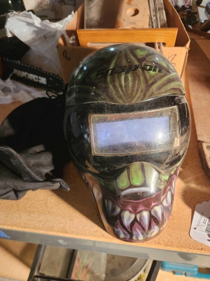 One Snap-on green skeleton welding helmet with two additional visor lens.