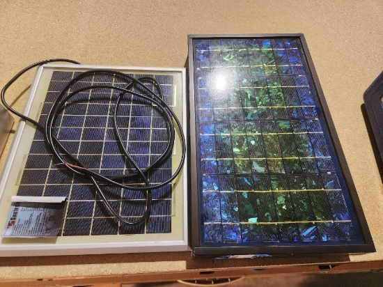 Two small solar panels. One is 14" x 12" and one is 17 1/2" x 10" x 2" in metal frame.