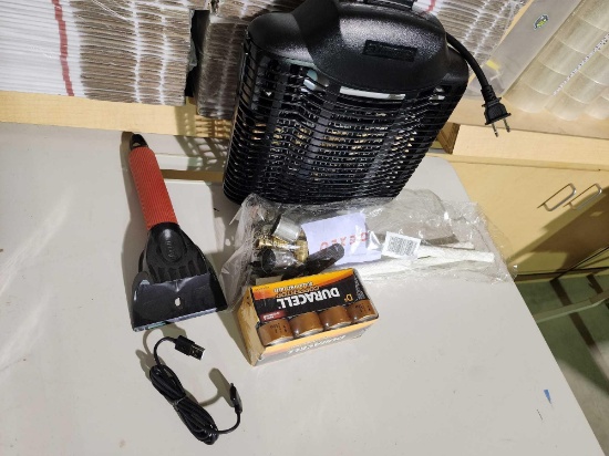 One electric bug zapper, new pack of D batteries, ice scraper and Tiki torch wicks.