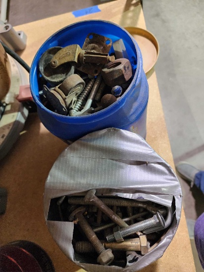 Two coffee cans of miscellaneous nuts and bolts.