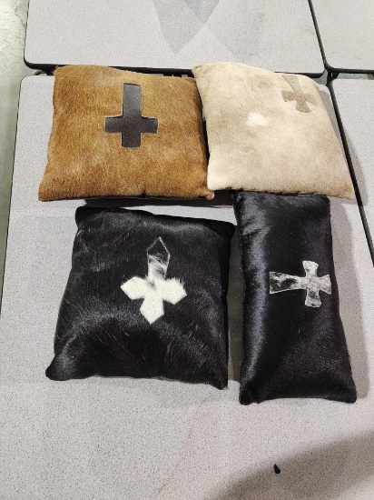 Four leather and animal hair throw pillows. Like new.