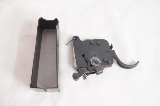 What appears to be a Remington trigger and a 700 magazine well. Used.