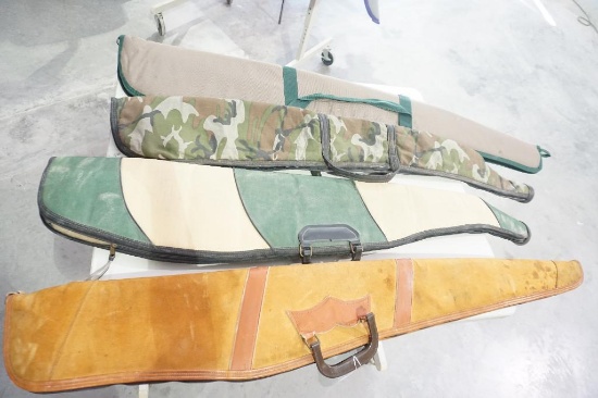 Four soft sided padded rifle cases. Used.