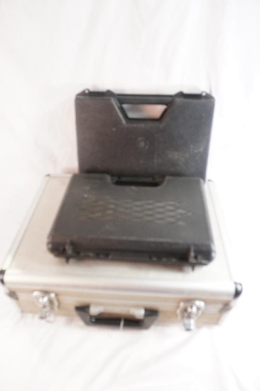 Two small black plastic pistol cases, and hard side aluminum multi pistol case. Used.