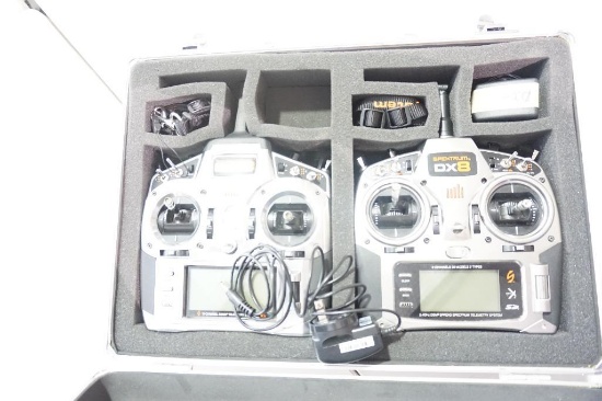 One aluminum RC case with two remote controllers, one empty RC controller box, and one empty RC