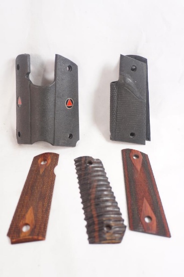 Three sets of 1911 grip panels. One wood and two rubber wrap around.