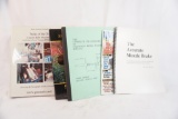Six books on firearms. One spiral and six soft cover, and one Handgun magazine.