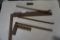 One framing square, small wood and metal square, blacksmith's tongs, and metal pry bar.