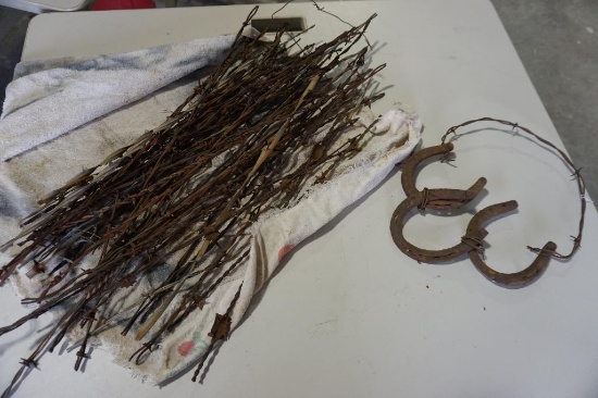 Bundle of barbwire samples. and a horse shoe hanger.