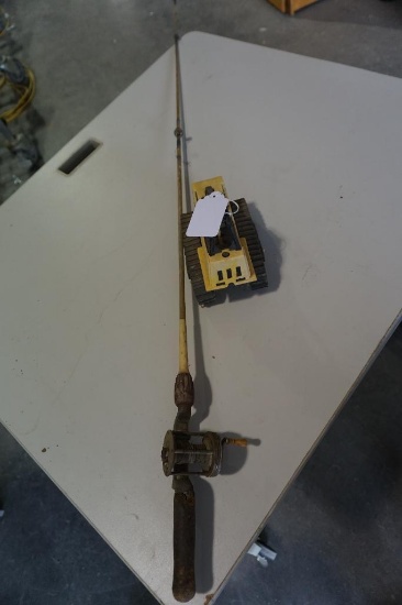 Old baitcasting rod and reel, toy caterpillar.
