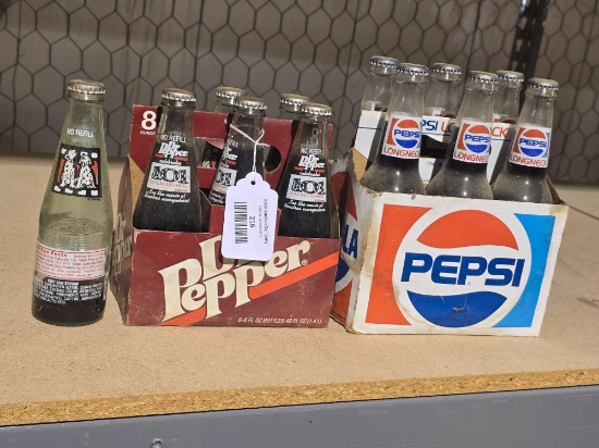 One 6 pack of 8 oz Dr. Pepper "101 Dalmatians", and one 6 pack of Longneck 12oz Pepsi.