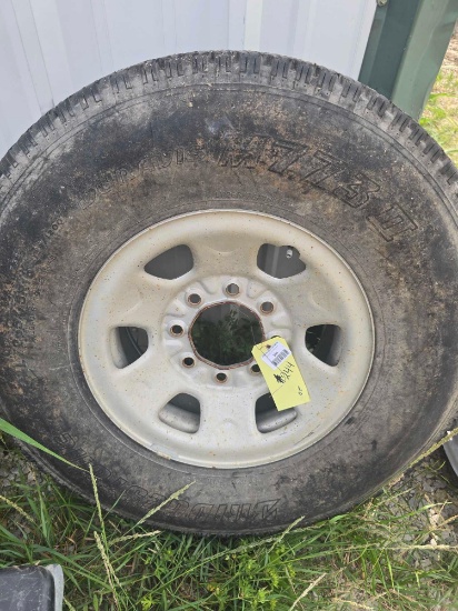 One truck tire and 8 hole rim, size LT 265/75R16. Used.