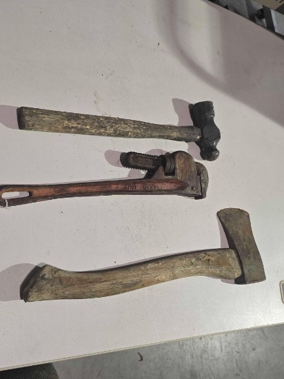 One hatchet, one ball peen hammer, and one 18" pipe wrench. Used.