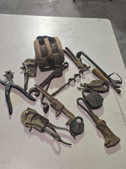 One old wooden pulley, two old pipe wrenches, two vintage wire pullers, old lock, etc.