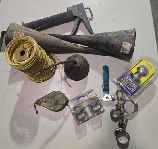Roll of 12 ga wire, trailer hitch, oil can, caulking gun, two funnels, etc.