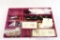 Plastic box of gun cleaning brushes and patch loops, new in pkgs