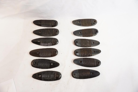 Twelve plastic Remington butt plates