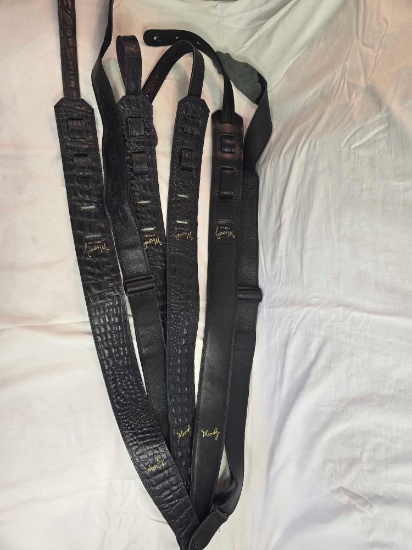 Six leather guitar straps.