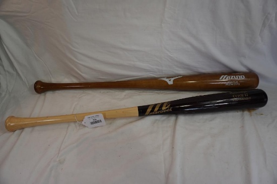 Two wood bats, and a jar of glove cream condition.