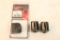 Three Ruger 10-22 magazines, one left and two right handed, and one Ruger 10-22 coupler.