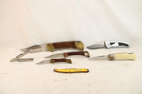 Six folding pocket knives and one multi tool