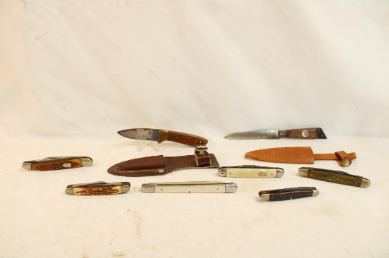 Six small folding pocket knives and 2 small fixed blade knives with leather sheaths