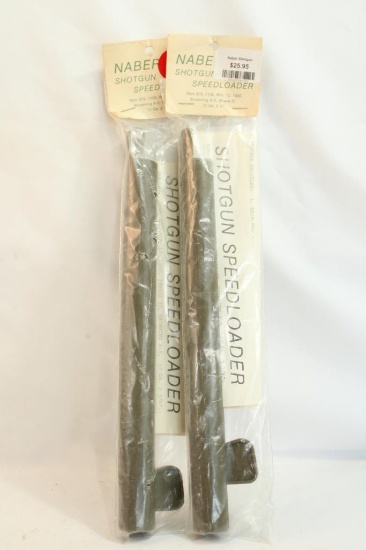 Two shotgun speed loaders, in packages.