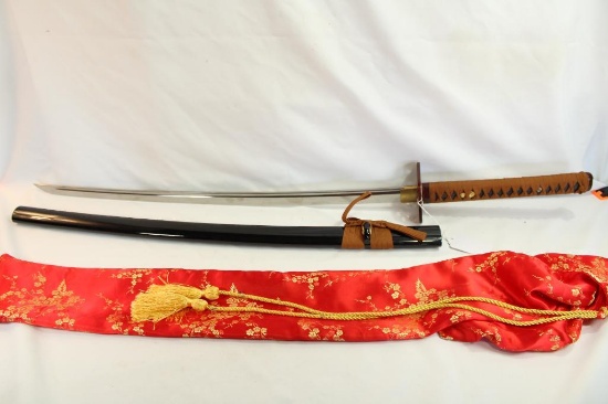 One double pin handle release Samurai sword in silk bag.