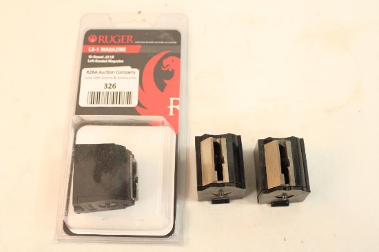 Three Ruger 10-22 magazines, one left and two right handed, and one Ruger 10-22 coupler.