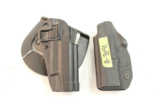 One Blackhawk right handed paddle holster with trigger release, and one pole craft belt clip